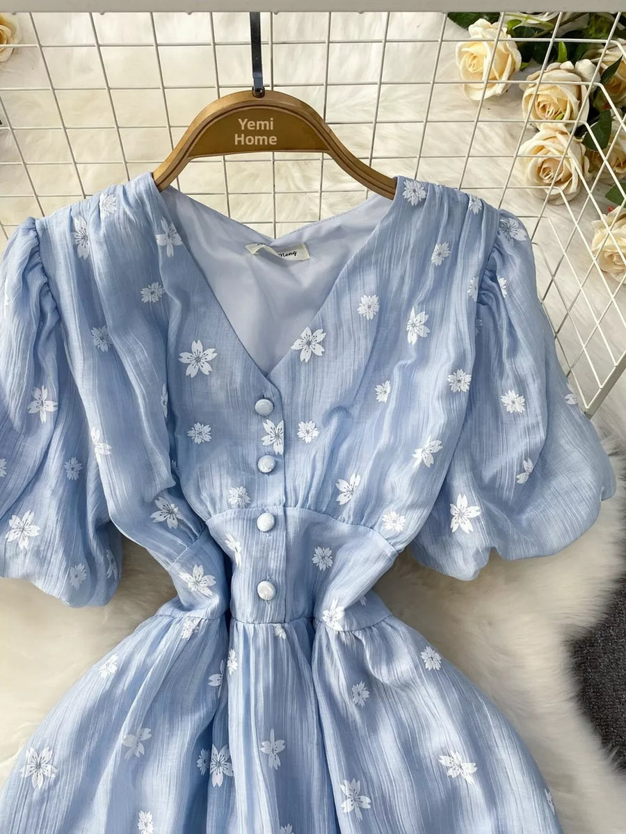 Light blue embroidered puff sleeve midi dress with V-neck and button front.