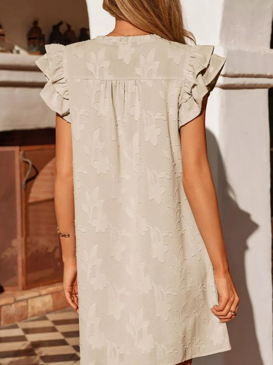 Apricot floral embossed mini dress with ruffle sleeves and a gathered neckline.