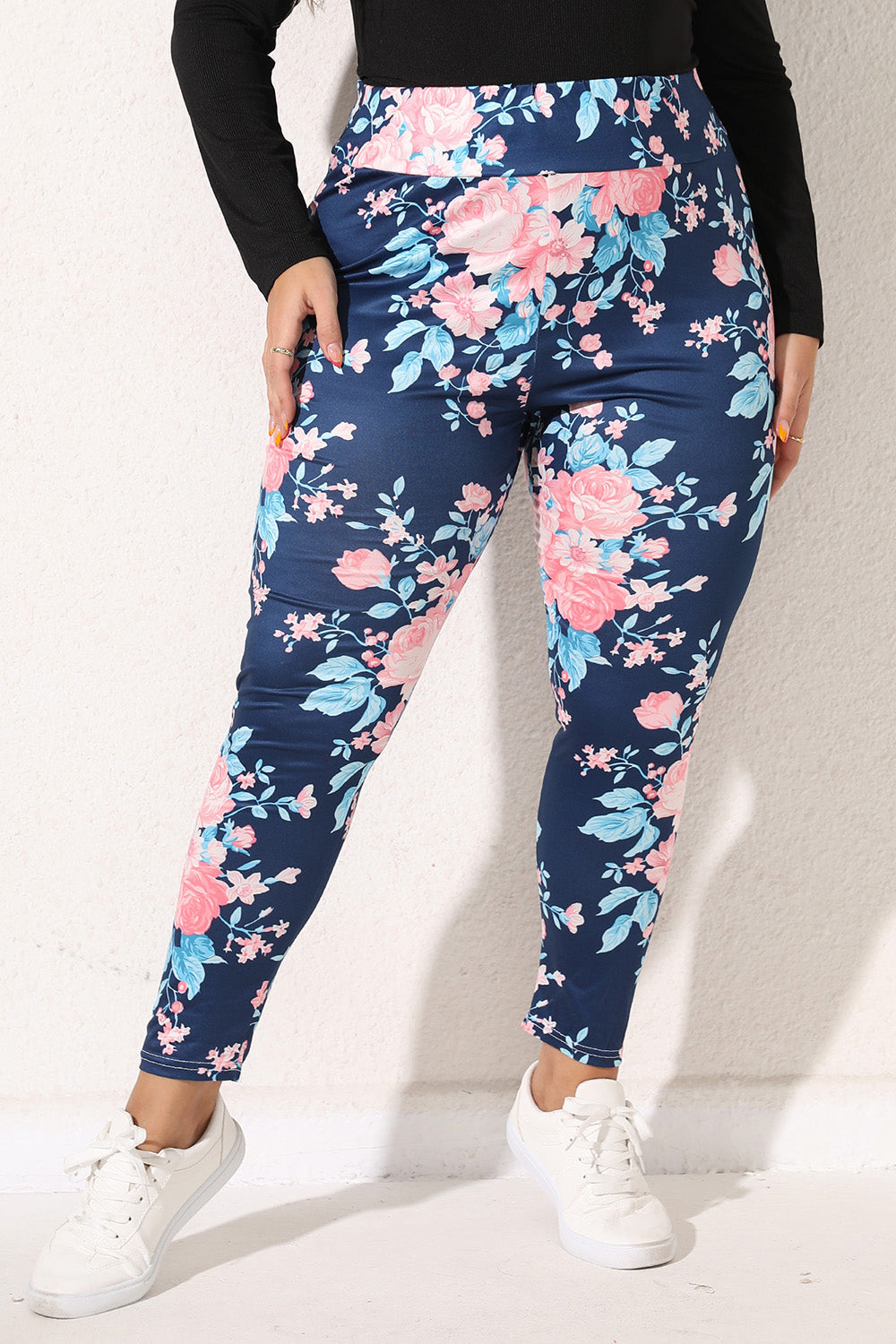 Floral bloom print leggings in peacock blue with pink and light blue flowers.