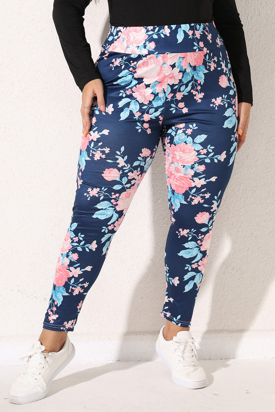 Floral bloom print leggings in peacock blue with pink and light blue flowers.