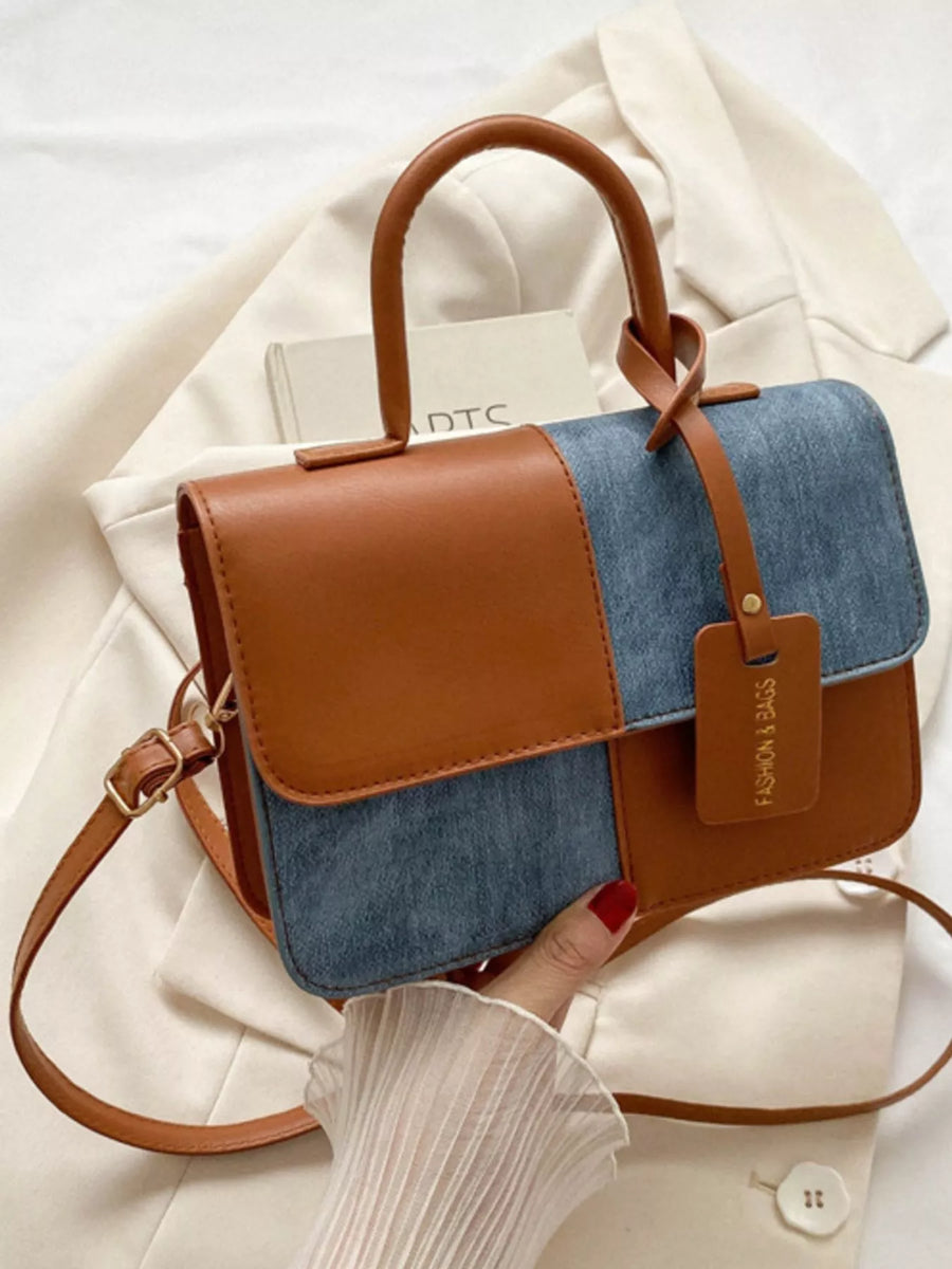 Chic two-tone PU leather handbag with denim panels and top handle.