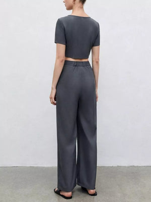 Chic square neck crop top and wide-leg pants set in dark gray, buttoned detail.