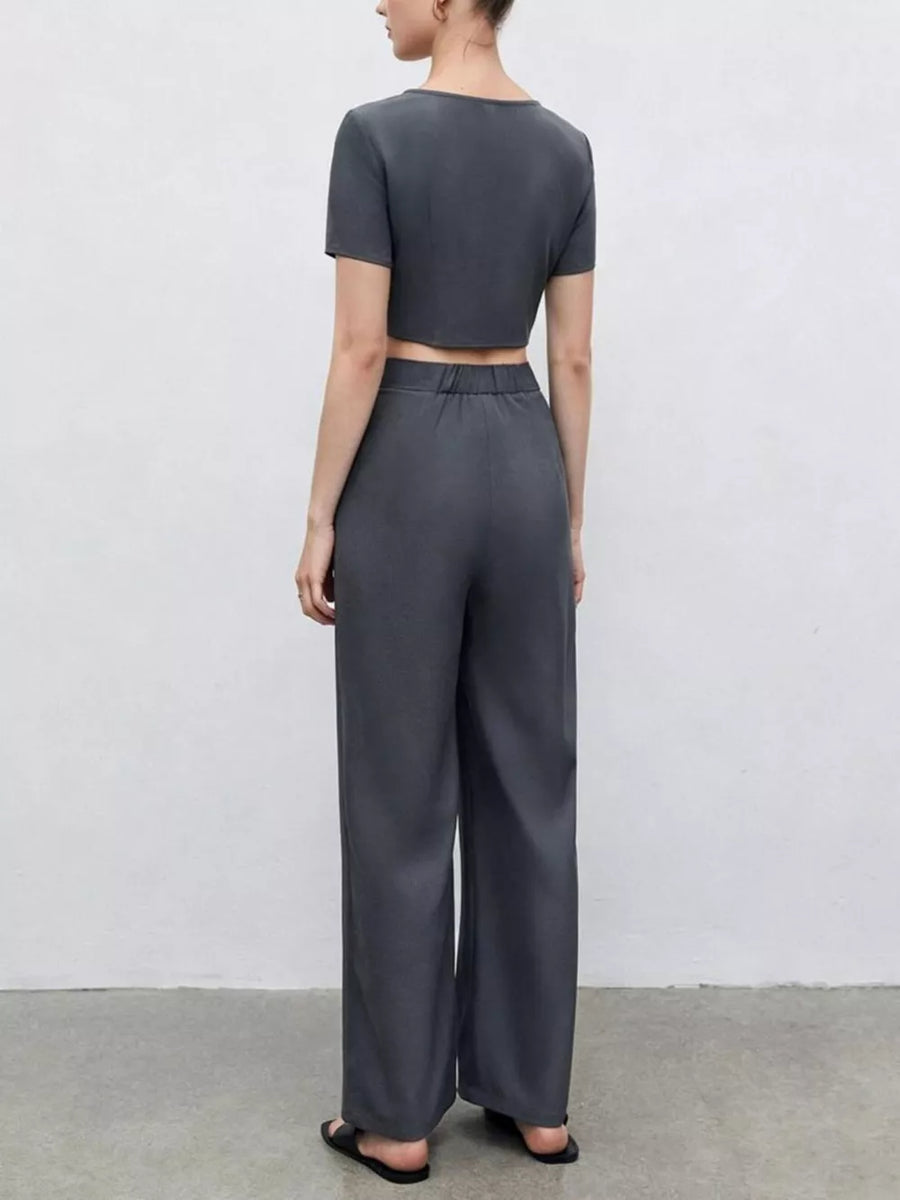Chic square neck crop top and wide-leg pants set in dark gray, buttoned detail.