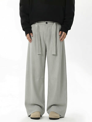 wide-leg pants in light gray featuring belted and flared fit