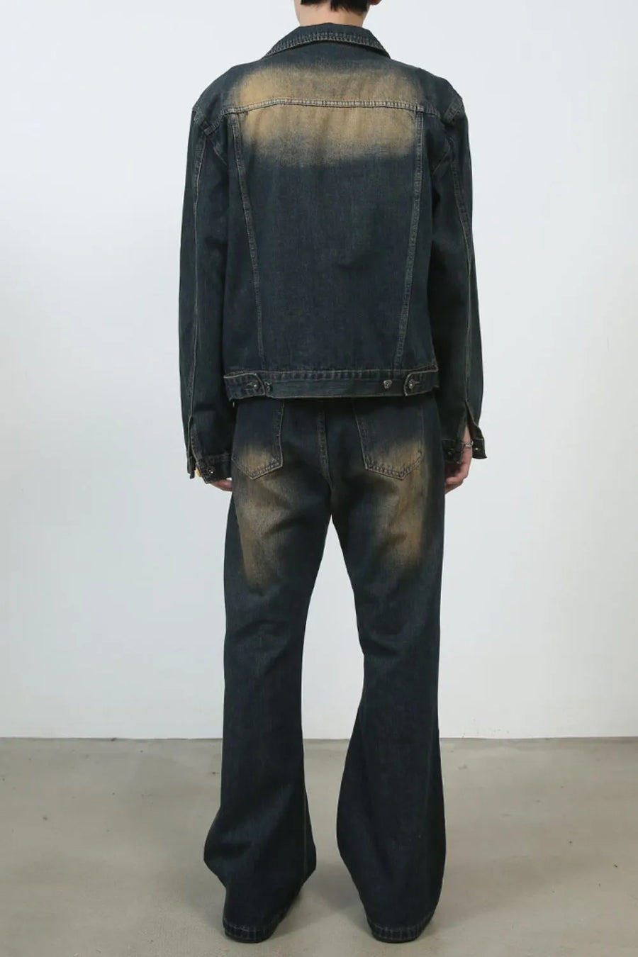 Dark wash denim flare jeans with vintage fading and baggy fit.