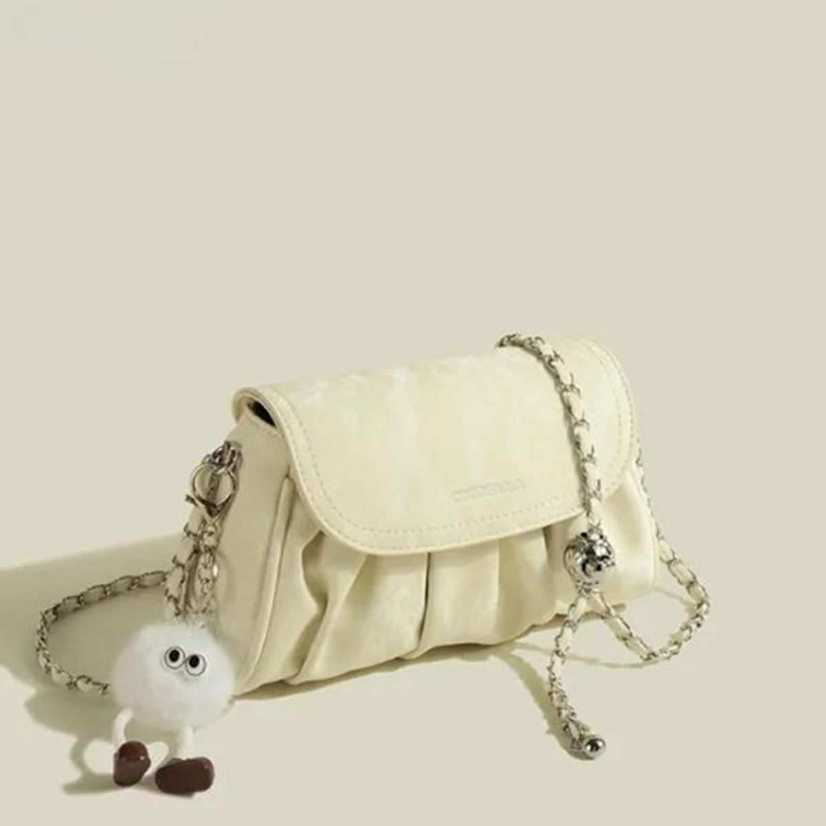 Mini ruched pu leather shoulder bag in pastel yellow with chain strap and fuzzy charm
