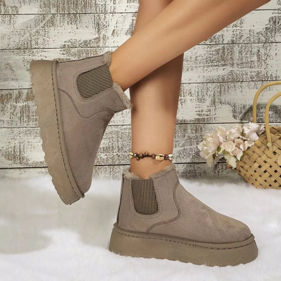 Beige suede round toe platform ankle boots with elastic side panels and faux fur trim.