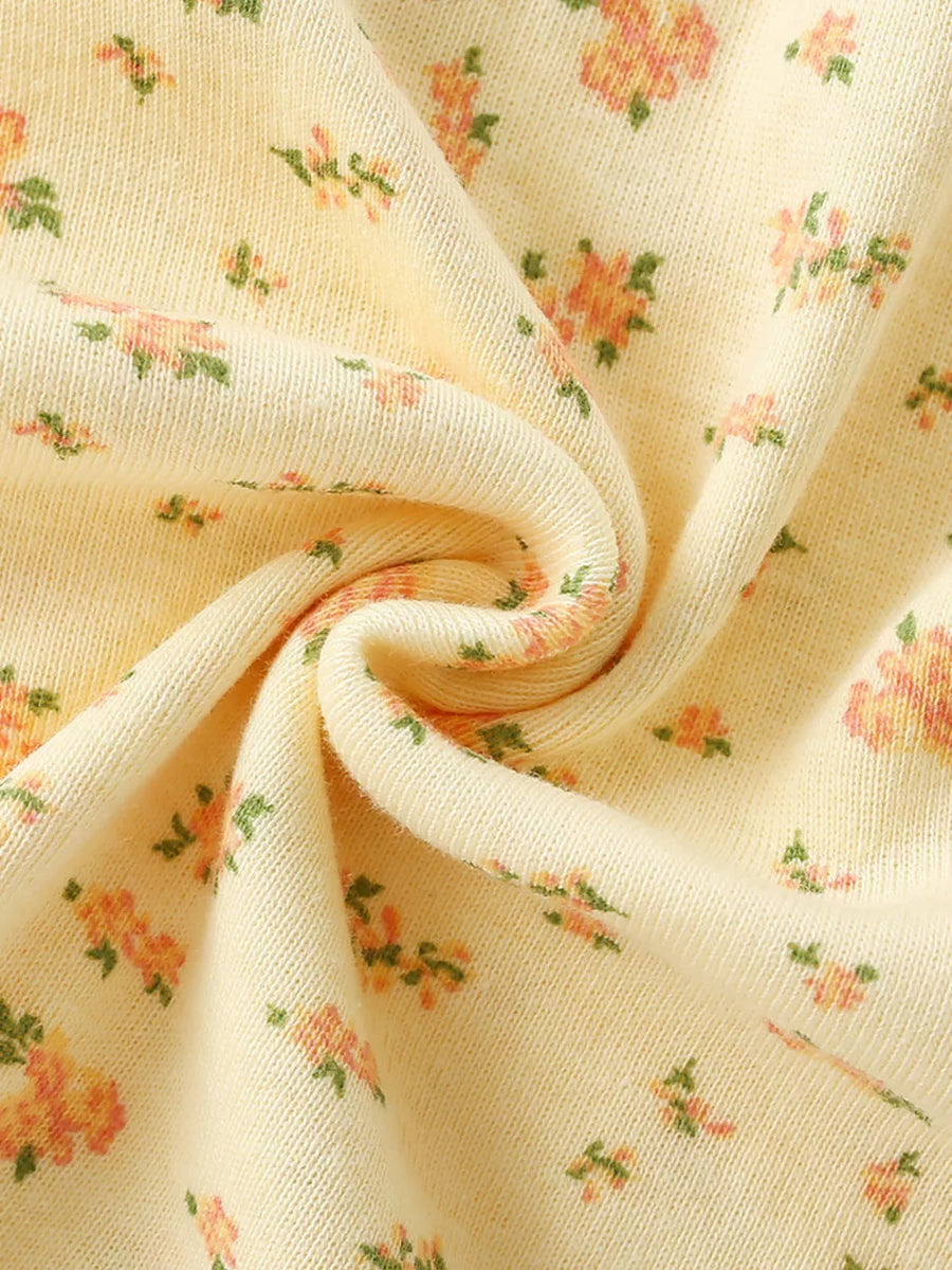 Delicate floral toddler dress in light yellow with short sleeves and a casual, basic style.