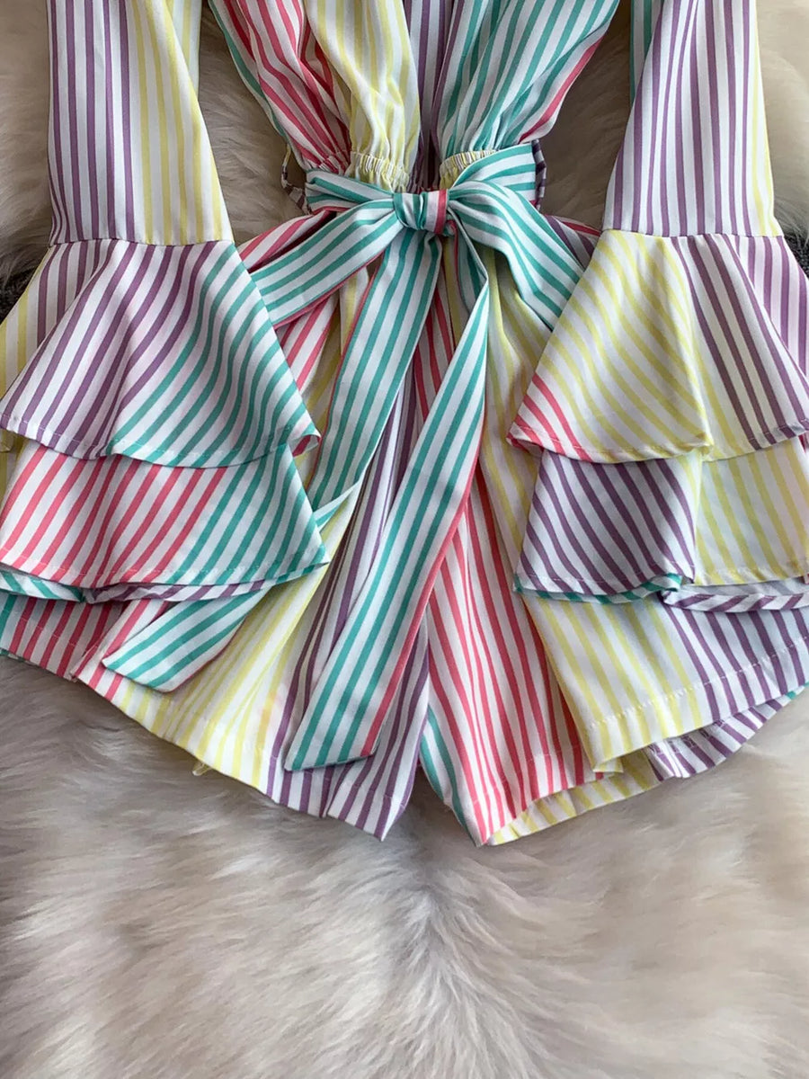 Color striped romper with tiered ruffles and a bow belt detail.