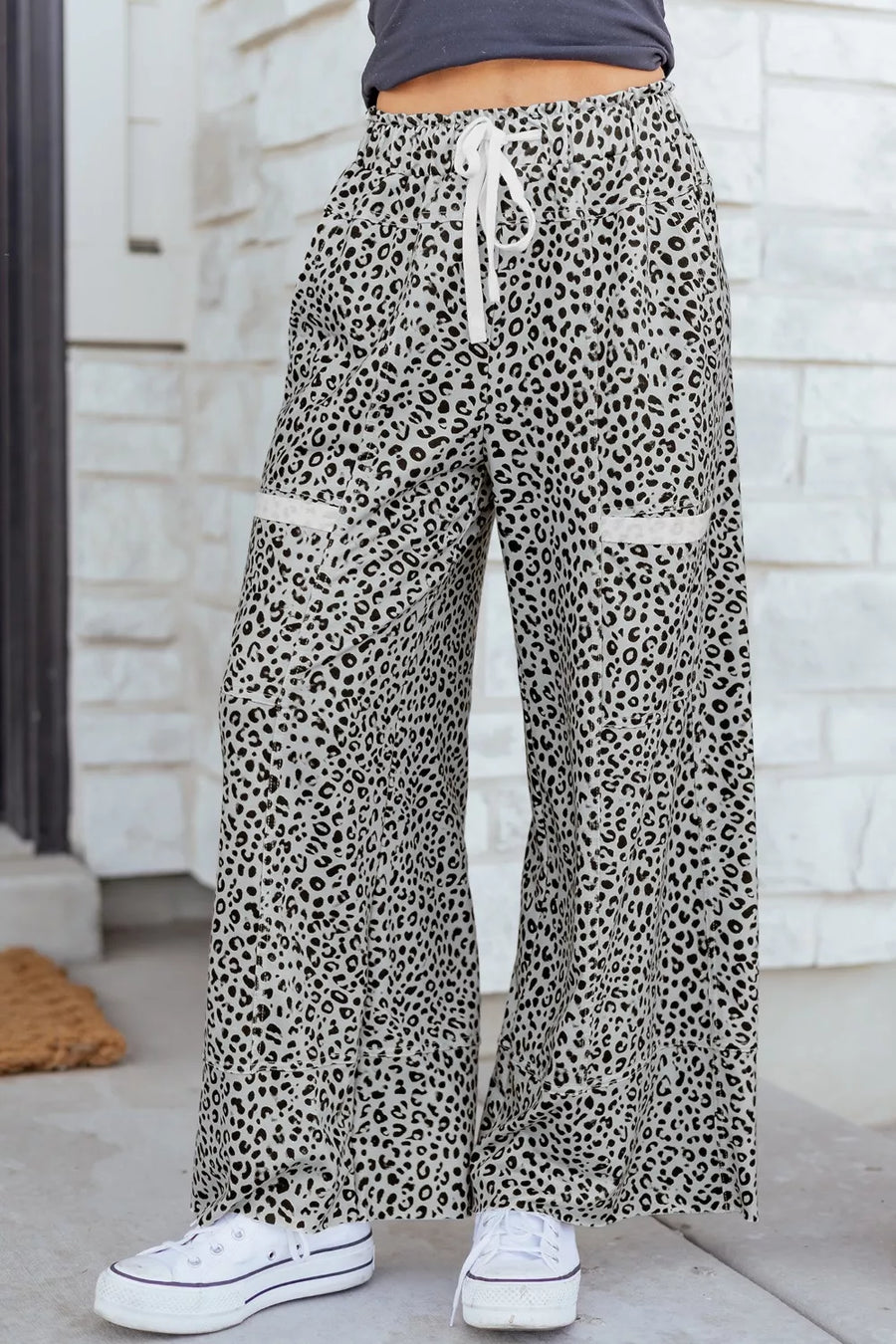Animal print wide leg pants with drawstring waist and contrast trim pockets.