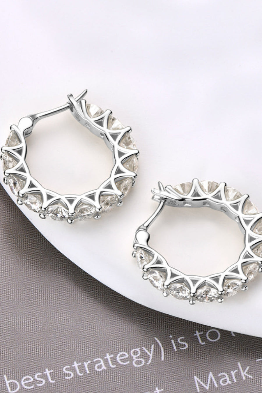 Silver moissanite pavé hoop earrings with clear stones.