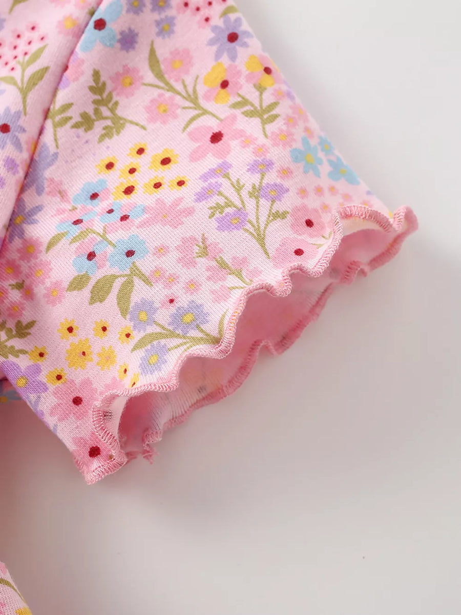 Pastel floral print cotton dress with ruffled sleeves and hem.