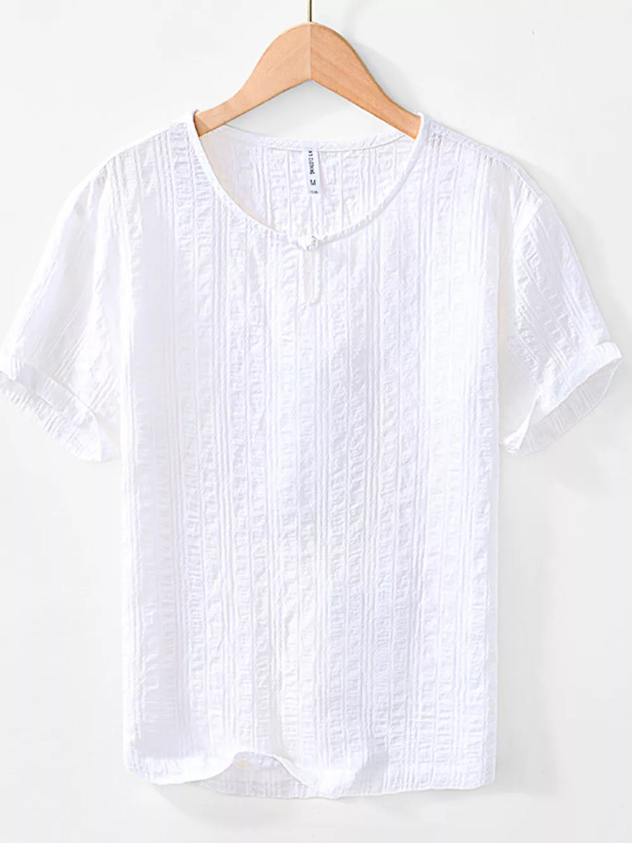 Men's white textured short sleeve cotton blouse with a button detail at the neckline.