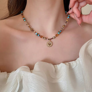 turquoise necklace featuring beaded and motif