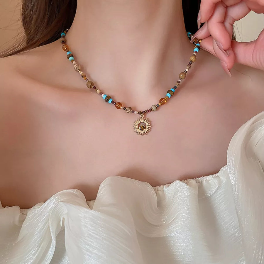 turquoise necklace featuring beaded and motif