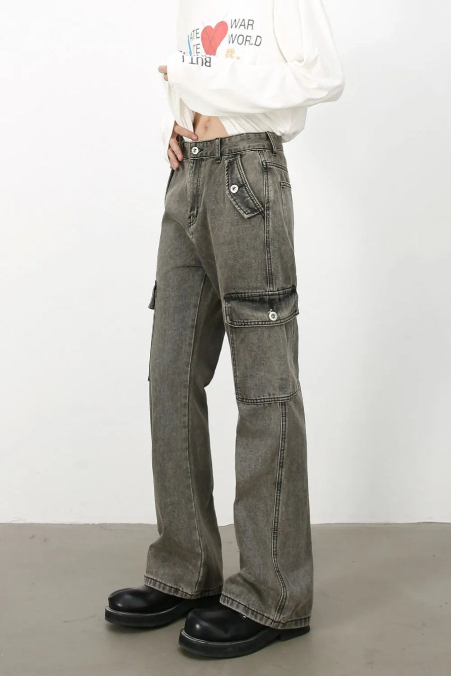 Faded dark gray denim flare cargo trousers with multiple pockets and a relaxed fit.