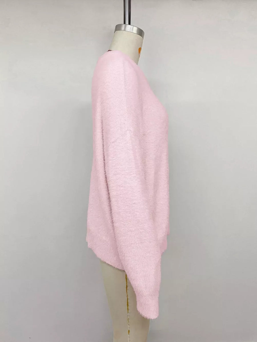 Pink fuzzy crewneck sweater with long sleeves.