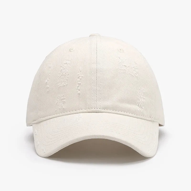 Distressed cotton baseball cap in ivory with subtle rips and tears.