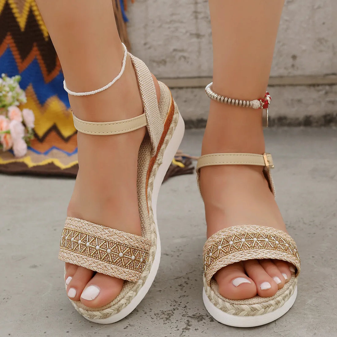 Beige embroidered espadrille platform sandals with ankle strap and jute sole.