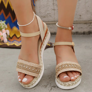 Beige embroidered espadrille platform sandals with ankle strap and jute sole.