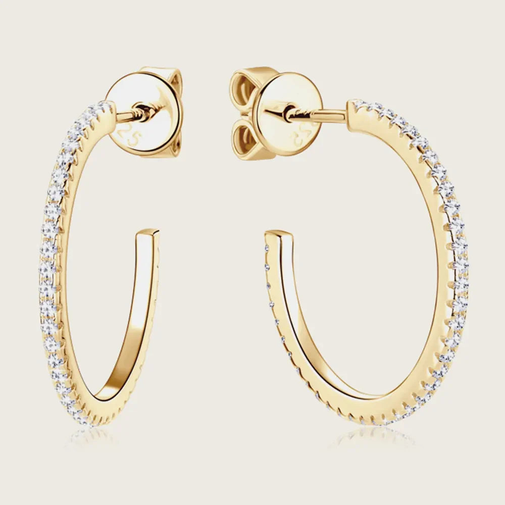 Gold C-hoop earrings with pavé-set clear stones and 18K gold plating.