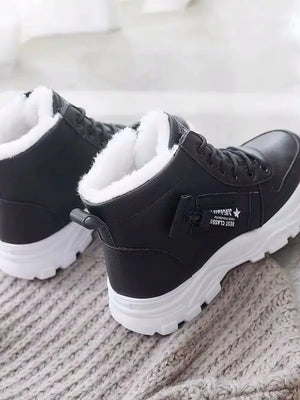 Black faux shearling lined platform boots with white soles and side detail.