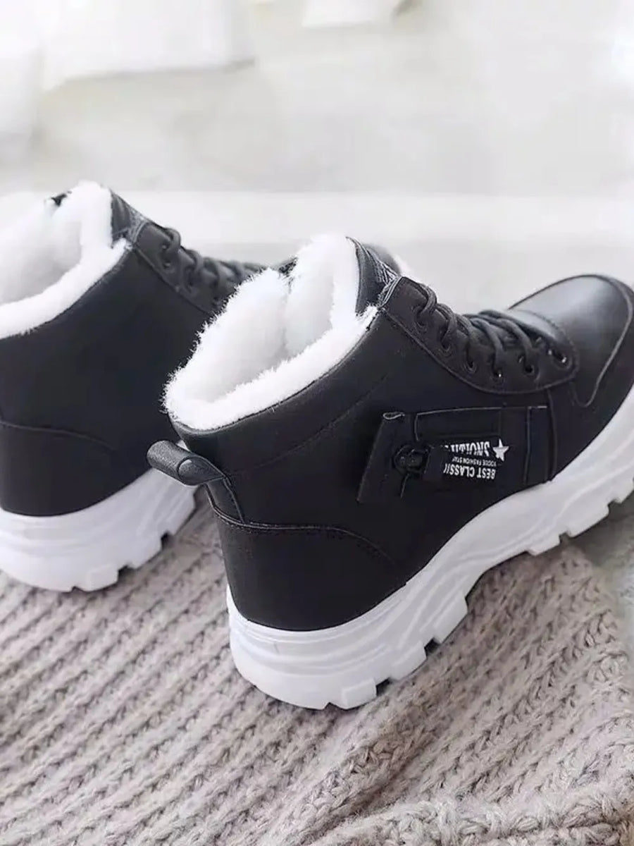 Black faux shearling lined platform boots with white soles and side detail.