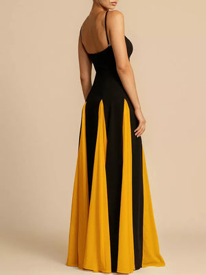 Elegant black and yellow maxi dress with spaghetti straps and a flowing skirt.