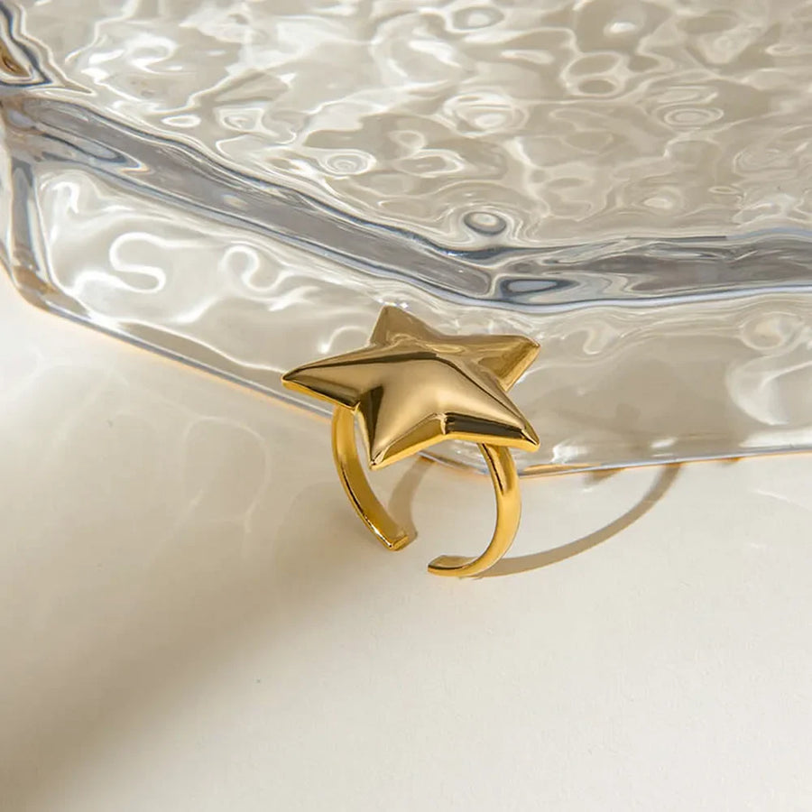 Gold starburst adjustable ring with a bold, sculpted design.