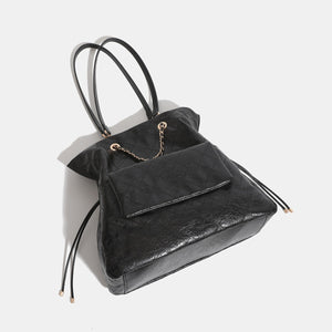 backpack in black featuring quilted and boxy fit