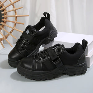 Black lace up platform casual sneakers with hook and loop straps and chunky soles.