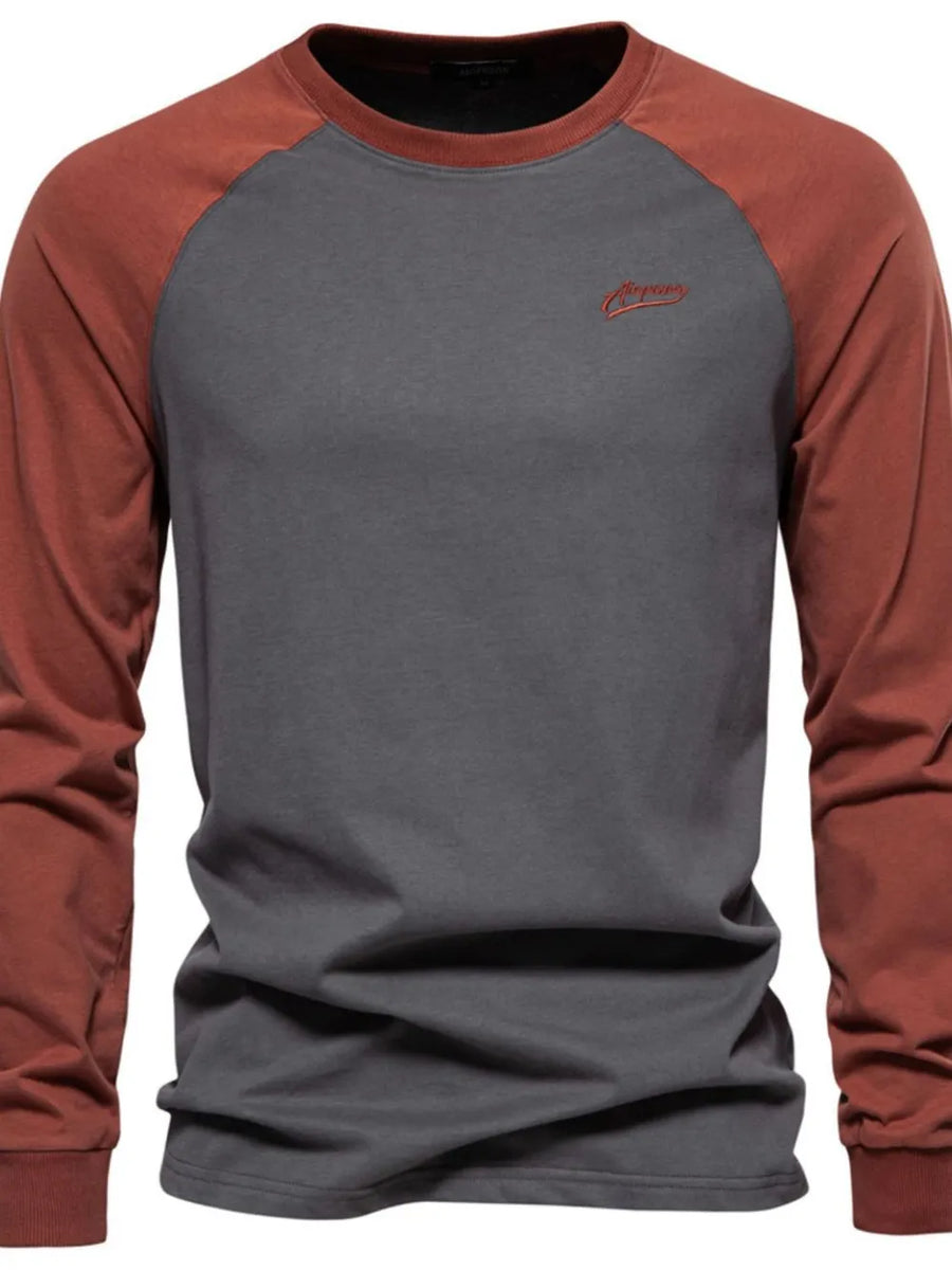 Colorblock raglan tee in gray with rust sleeves and embroidered logo detail.