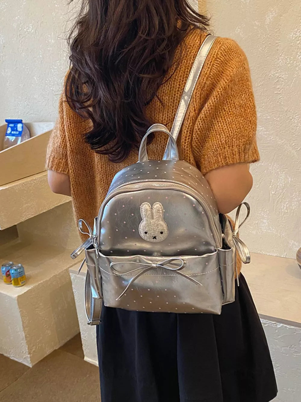 Silver backpack featuring bunny appliqué and polka dot