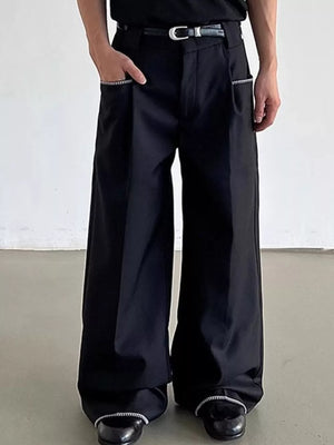 Relaxed fit wide-leg black pants with decorative trim on pockets and hem