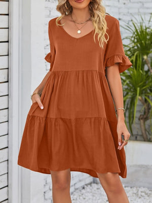 Caramel ruffled sleeve mini dress with pockets and tiered skirt.