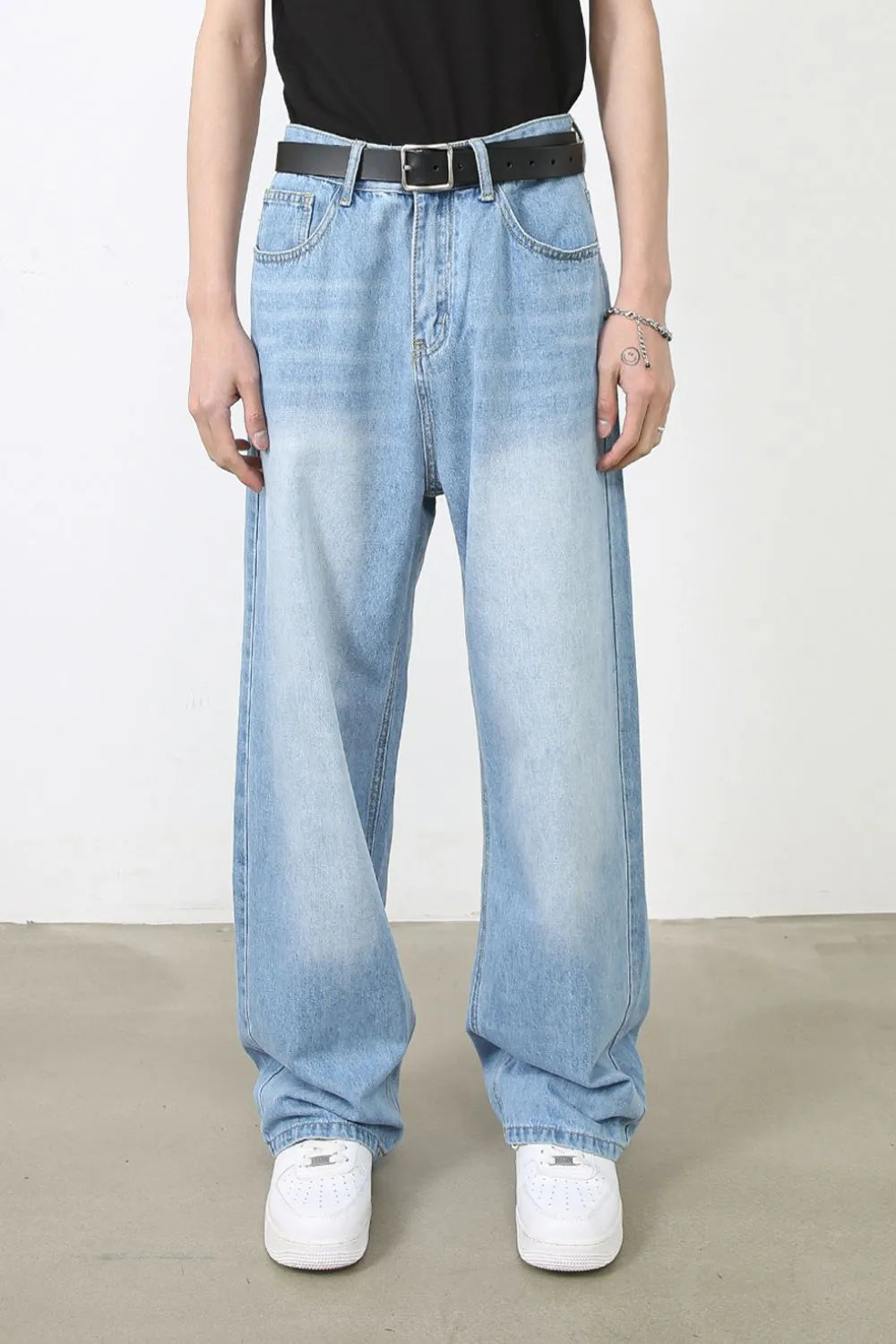 Faded light blue denim baggy jeans with a relaxed fit and casual style.
