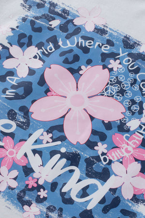 White graphic tee with pink floral accents, leopard print, and text.