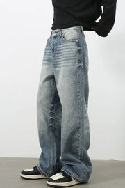 Baggy wash denim jeans in medium blue with a relaxed fit and distressed details.