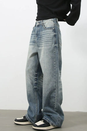 Baggy wash denim jeans in medium blue with a relaxed fit and distressed details.