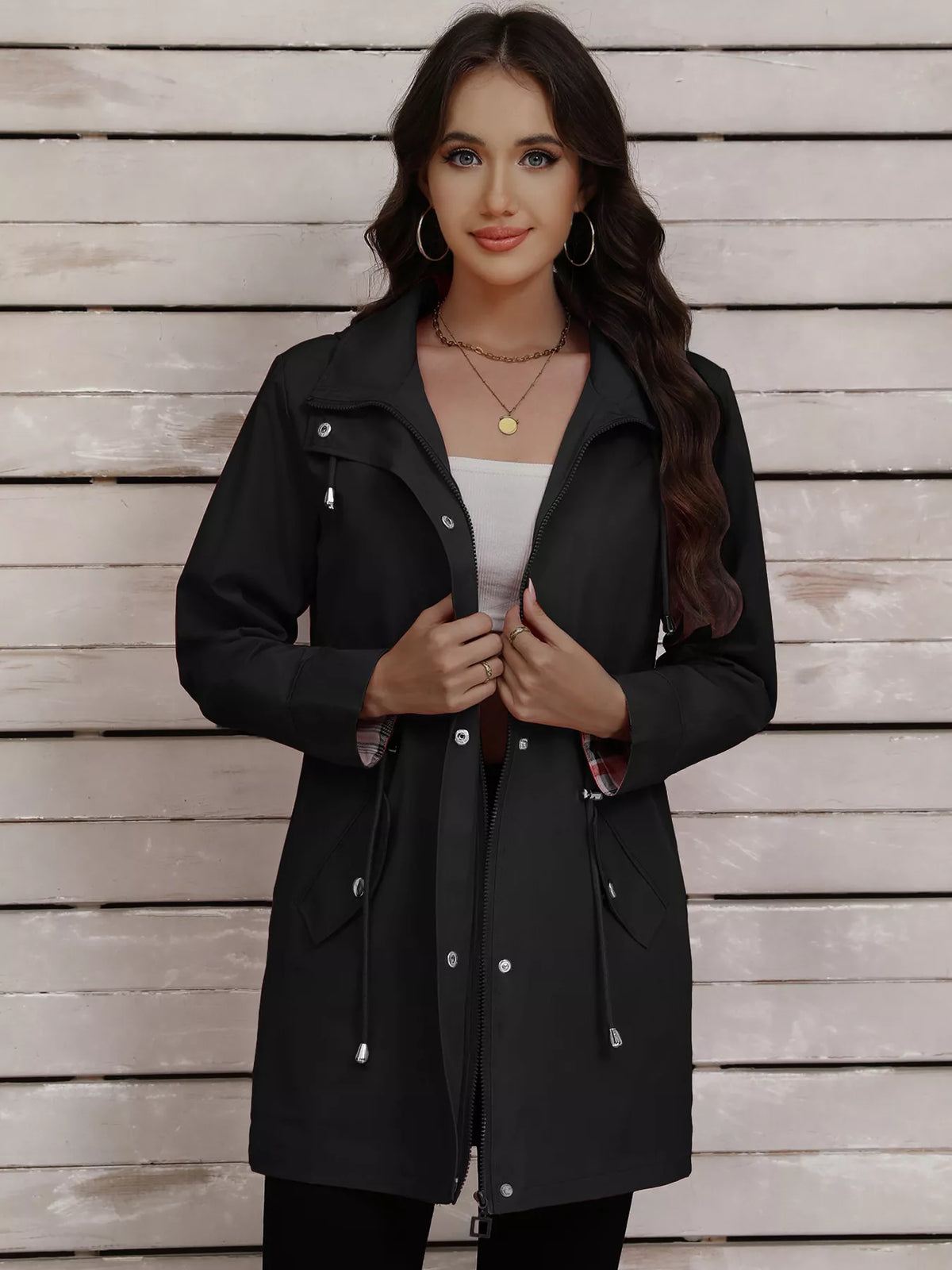 Black drawstring snap-down trench coat with plaid lining and silver hardware.