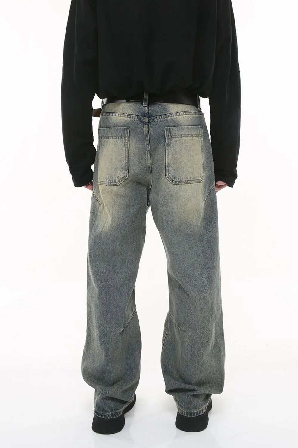 Vintage wash wide-leg jeans in dark gray with pleated detail and distressed accents.