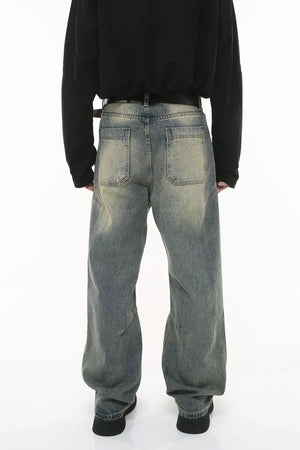 Vintage wash wide-leg jeans in dark gray with pleated detail and distressed accents.