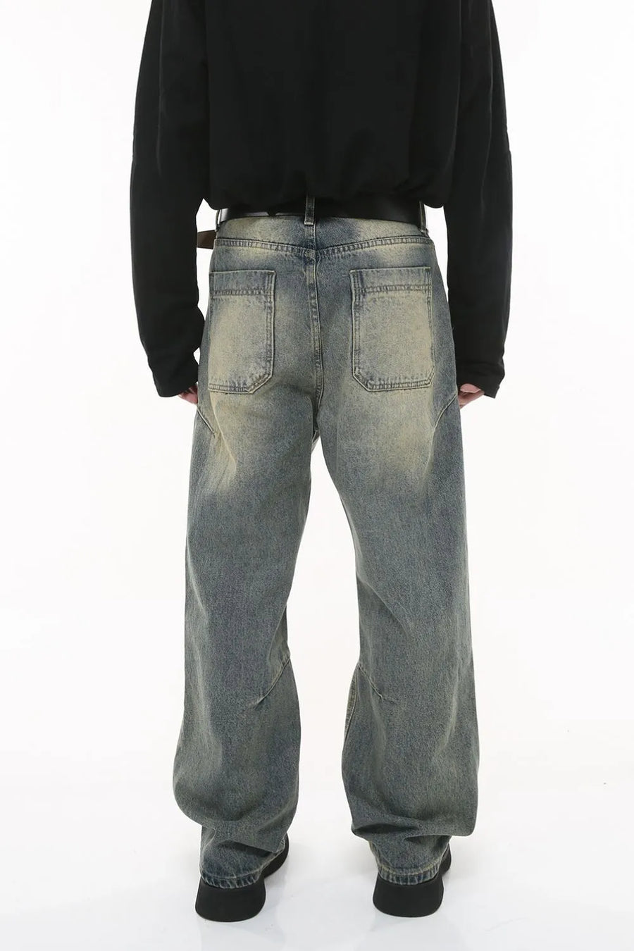 Vintage wash wide-leg jeans in dark gray with pleated detail and distressed accents.