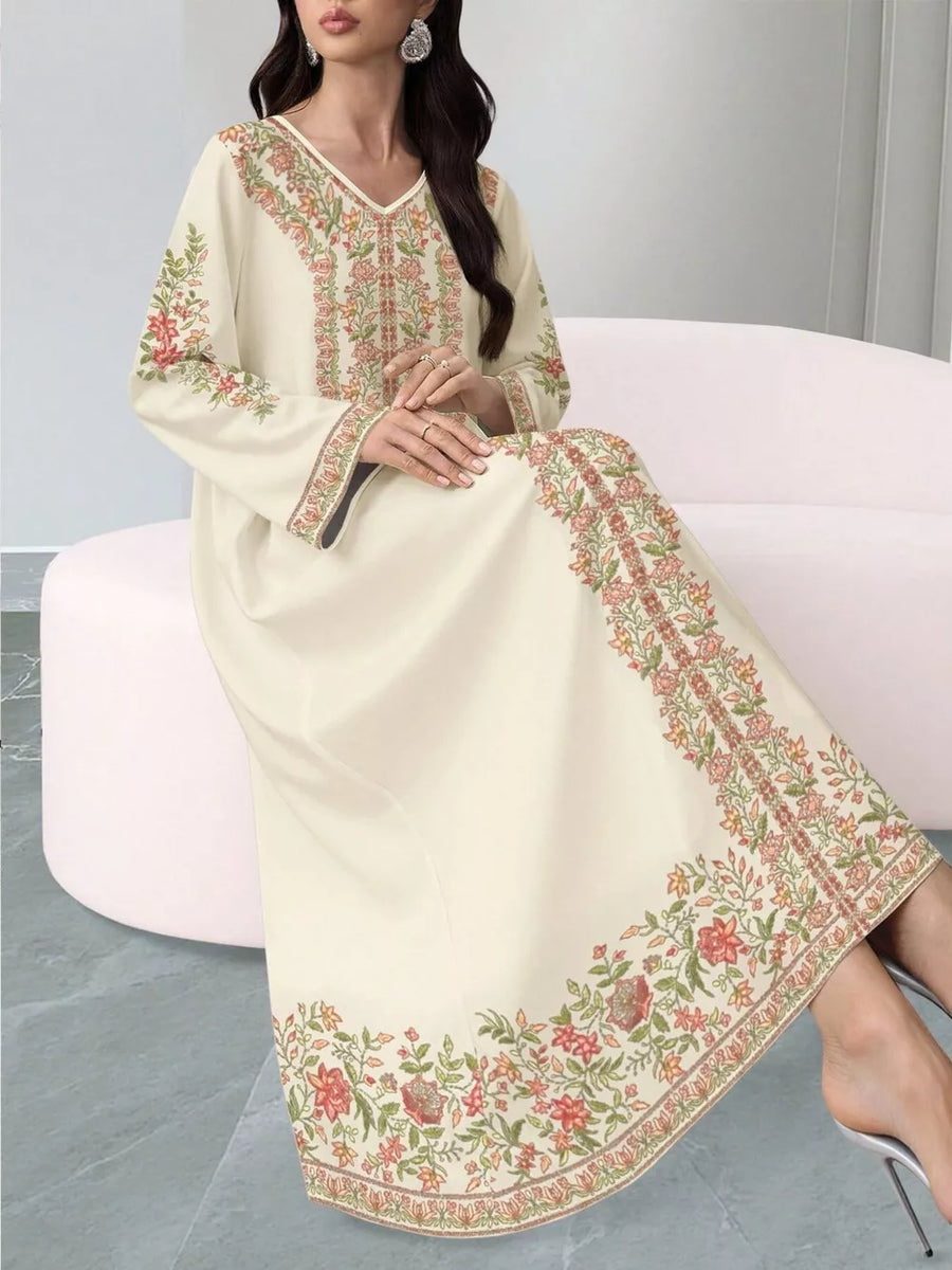Elegant floral maxi dress in cream with embroidered neckline and hem.