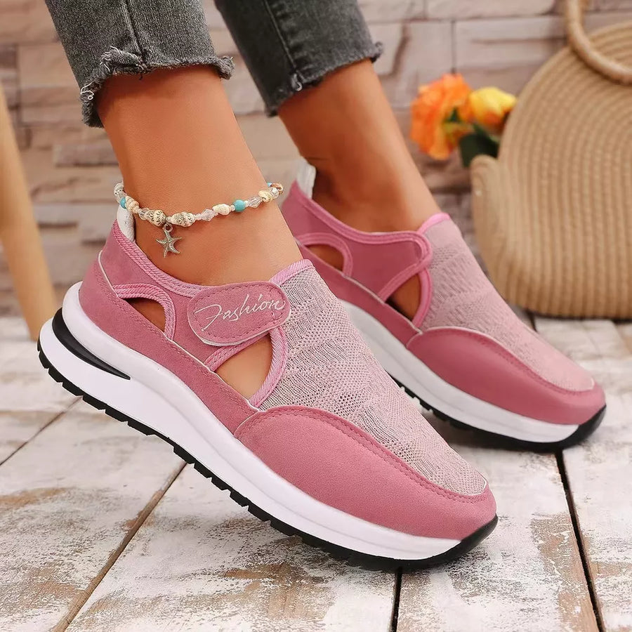 Pink breathable cutout slip-on sneakers with "Fashion" detail and white soles.