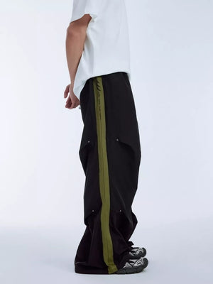 Black relaxed fit sweatpants with olive green side stripe and drawstring waist.