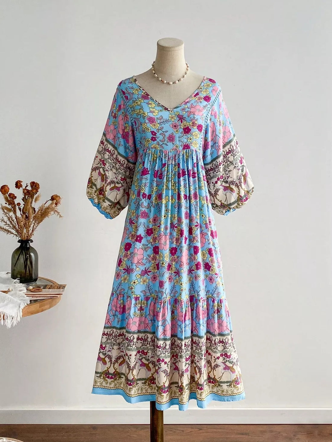 Light blue floral v-neck tiered maxi dress with bohemian print sleeves and hem.