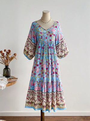Light blue floral v-neck tiered maxi dress with bohemian print sleeves and hem.