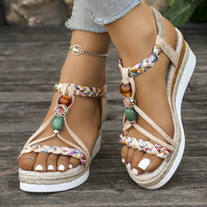 Bohemian espadrille wedges in beige with beaded straps and floral fabric accents.
