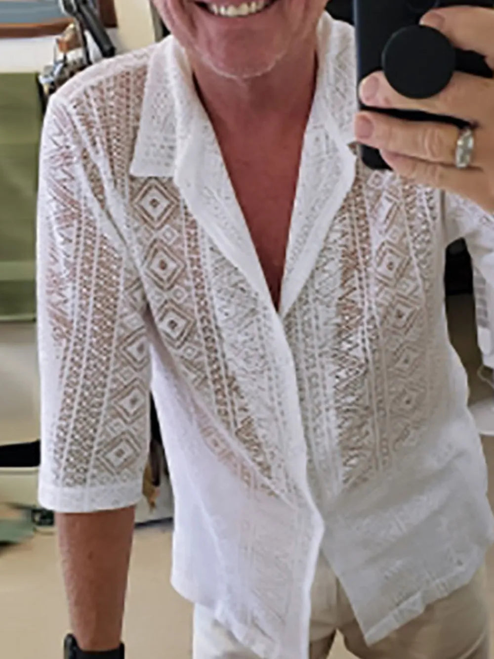 White crochet resort shirt with geometric pattern, button-up style, and 3/4 sleeves.